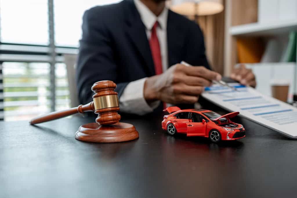 a lawyer is explaining the details of a car insurance policy to the car owner before she signs it, a lawyer explains to his client what will happen if she doesn't get car insurance