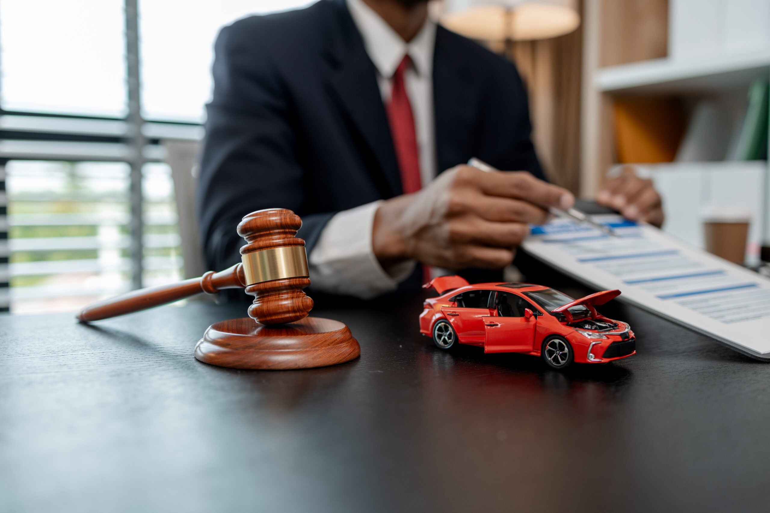 a lawyer is explaining the details of a car insurance policy to the car owner before she signs it, a lawyer explains to his client what will happen if she doesn't get car insurance